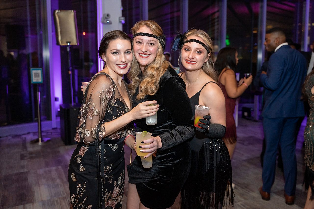 A group of 3 women dressed up in sexy Great Gatsby themed attire posing for the camera at DC's #1 New Year's Eve celebration - Capital Gatsby Gala New Year's Eve DC 2024