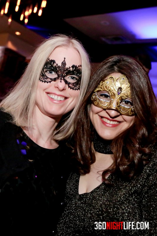 2 women in masquerade masks celebrating New Year's Eve in Washington DC at the National New Year's Eve Masquerade Ball by 360 Nightlife.