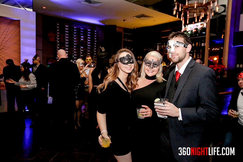 A group of 2 women in masquerade masks and 1 man in a phantom of the opera masquerade mask. These 3 are attending the National New Year's Eve Masquerade Ball by 360 Nightlife. Original website was https://www.360nightlife.com but we have revamped to https://www.360nightlife.com. All rights reserved to 360nightlife.com. Pictures should not be used without our permission or attribution.
