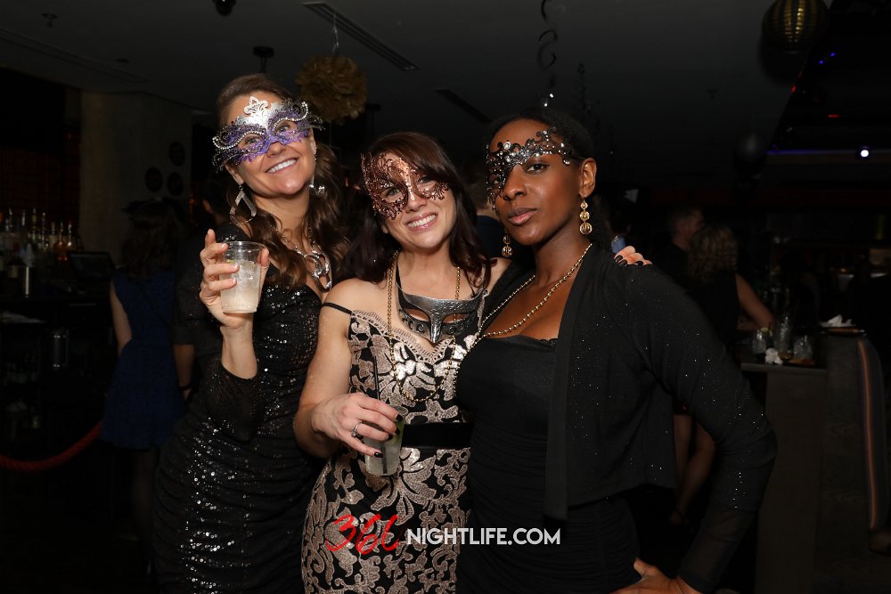 3 beautiful ladies posing at the National New Year's Eve Masquerade Ball at Umaya in City Center, Washington DC. One of Washington DC's longest running NYE events.