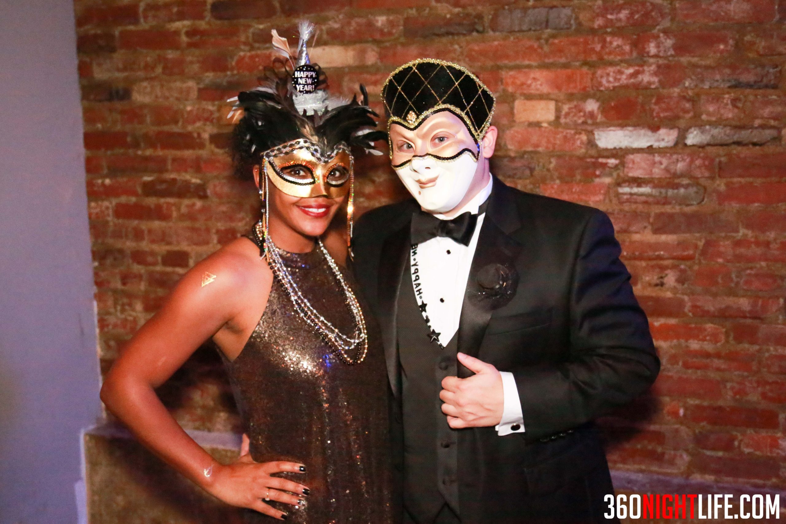 A black and white couple in masquerade masks at the National New Years Eve Masquerade Gala in Washington DC by 360 Nightlife.