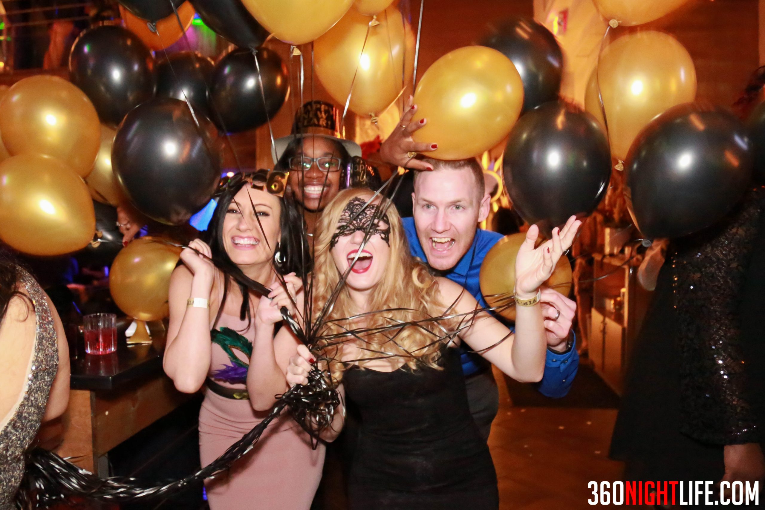 Group at the National New Years Eve Masquerade Ball holding Balloons, event in Washington DC by 360 Nightlife.