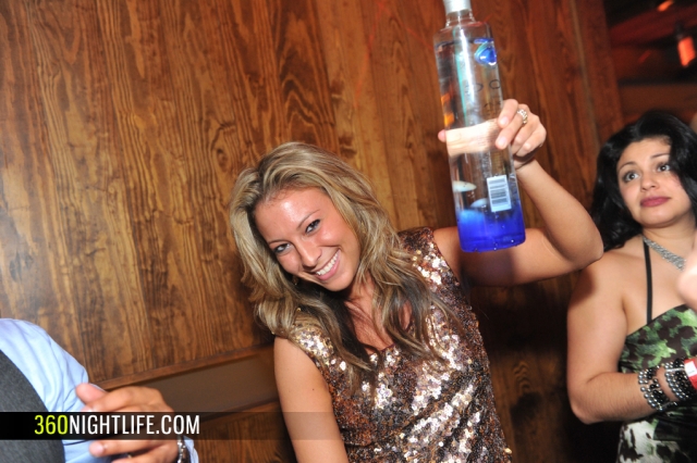 A woman holding up a ciroc bottle at National New Year's Eve DC Ball by 360 Nightlife